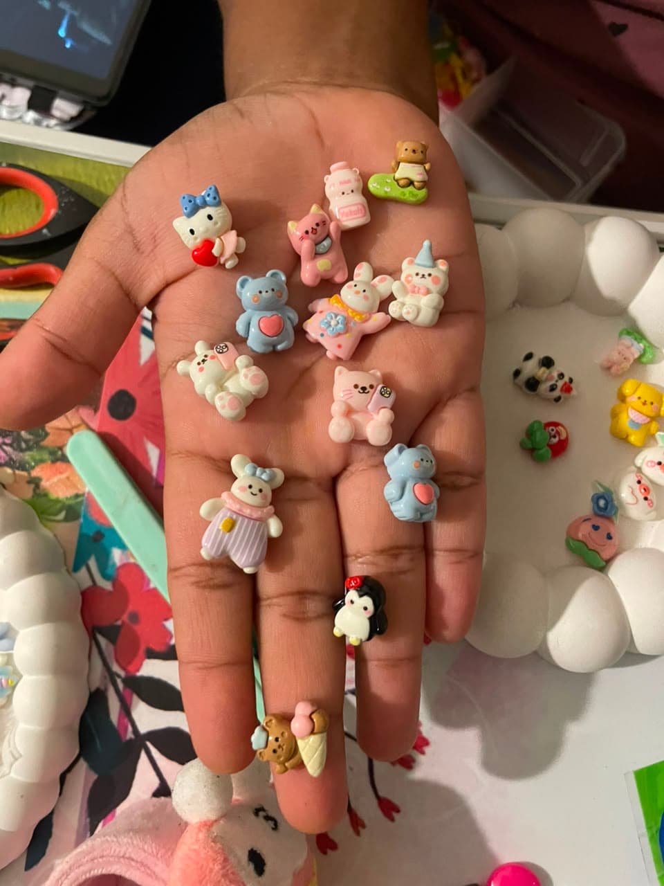 A handful of tiny charms ready to be placed